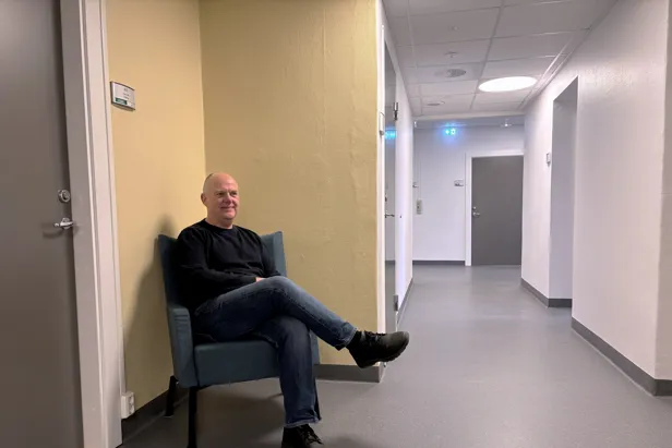 Vegg som er malt med en gulfarge. Gøran Fransson i sitter i en stol foran veggen.