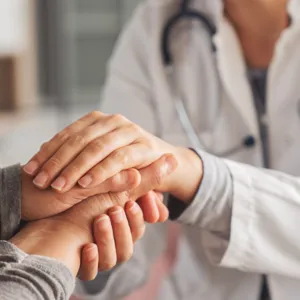 Illustrasjon: Lege holder en kreftpasienten i hånden