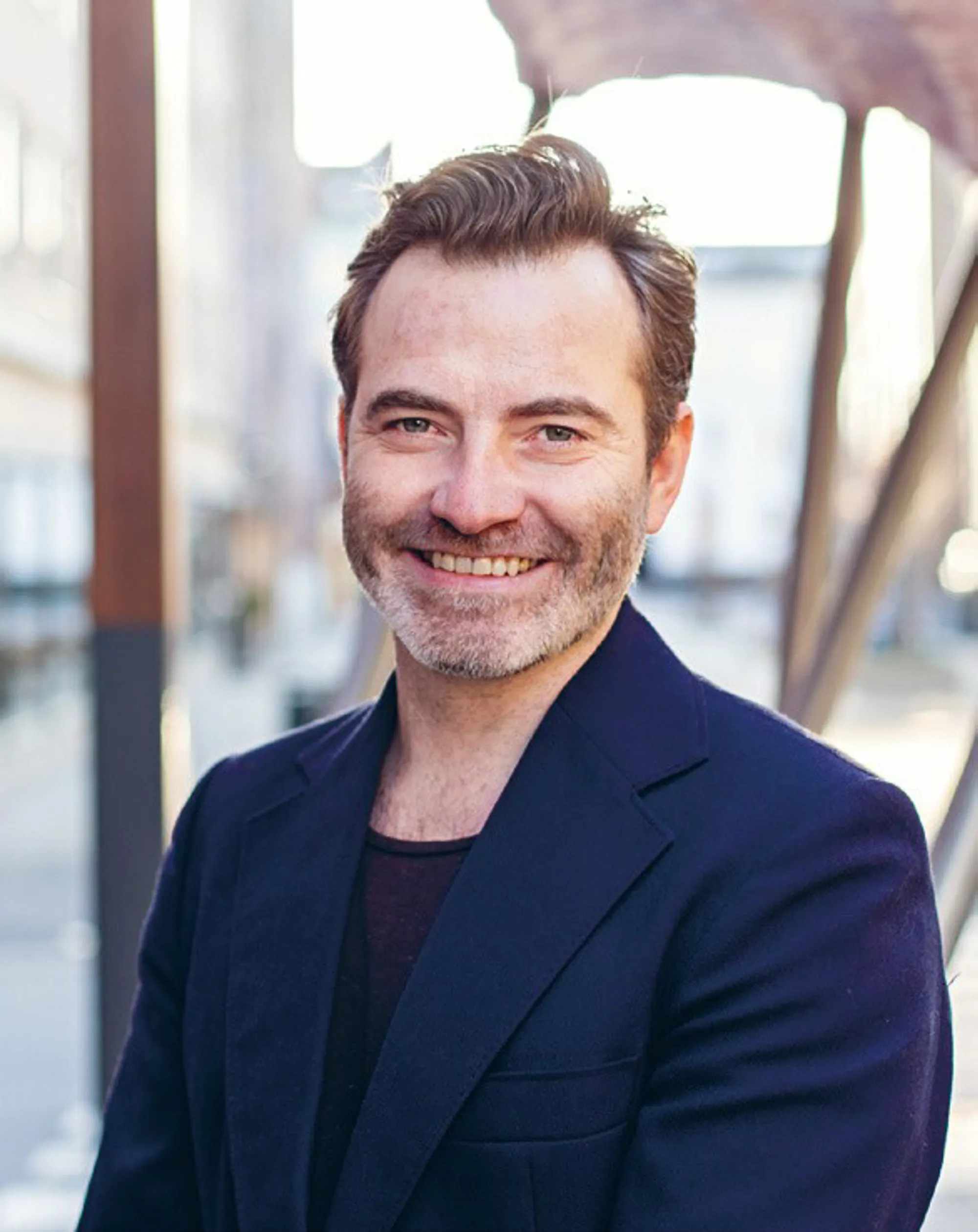 En mann som smiler til kameraet